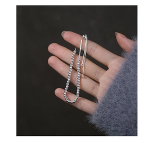 Close-up of adjustable silver beaded bracelet featuring a pull-string clasp mechanism