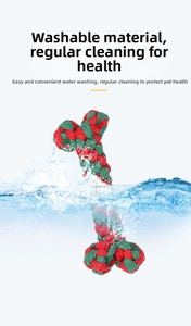 Washable red and green braided cotton rope dog toy in a bone shape with water splashes