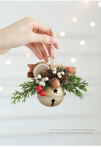 Close-up of golden Christmas bell with pine cones, red berries and stars cutouts
