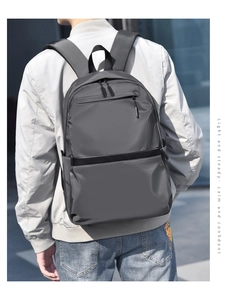 Close-up of lightweight grey business backpack with multiple zipper compartments