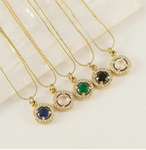 Detail of colorful zircon pendants in five colors on golden stainless steel chains