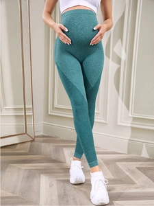 Detailed view of seamless mesh fabric and high waist support on maternity yoga pants
