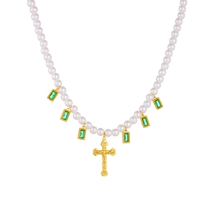 Vintage pearl necklace with gold cross pendant and green square gemstone accents