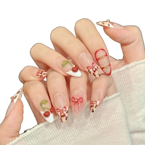 Pink almond press-on nails with red cherry, bow designs and leopard print accents