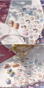 Detail view of 3D embossed puppy nail stickers and cute dog-themed press-on nails