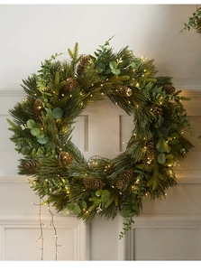Detail of Christmas wreath with realistic PE pine needles, cones and warm LED lights