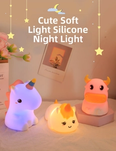 Three cute silicone animal night lights in unicorn and cow shapes with soft glow