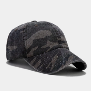 Detailed view of the washed camo canvas fabric and breathable eyelets on the baseball cap