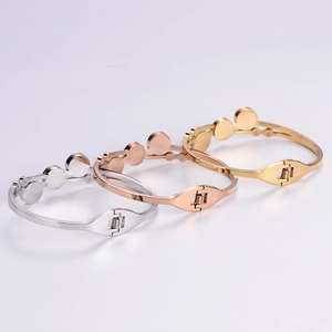 Three minimalist Roman numeral cuff bracelets in gold, rose gold, and silver stainless steel