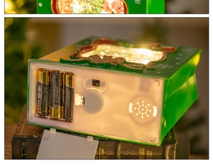Detail of Christmas lantern base showing battery compartment and music speaker holes