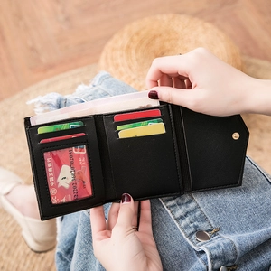 Mini black trifold wallet for women with leather texture and heart detail, interior view