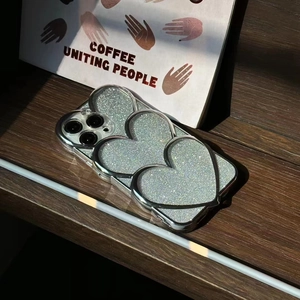 Close-up of glitter silver phone case with 3D stacked hearts for iPhone Pro models