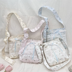 Detail of four cute silk texture lace crossbody bags with bear patterns in pastel colors