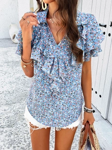 Detail of floral V-neck shirt showing ruffled layers on cuffs and front placket