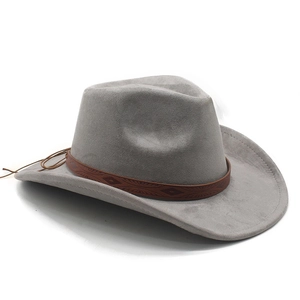 Detail of grey suede cowboy hat featuring brown leather band with embossed patterns