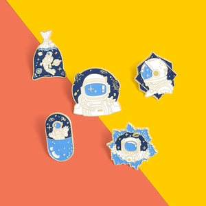 5-piece astronaut enamel pin set featuring cartoon spaceman designs in blue and gold finish