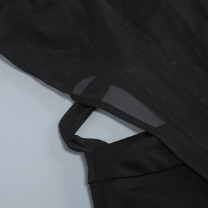 Close-up of black mesh stitching and hollow-out waist detail on a jumpsuit