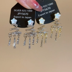 Detail of S925 silver star tassel earrings with rhinestones in gold and silver finish