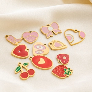 18K gold plated stainless steel strawberry and heart enamel charms on silk fabric