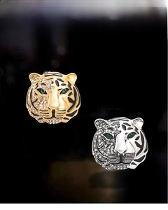 Detailed comparison of gold and silver tiger head brooches with crystal and green gems