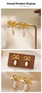 Detail of 18K gold bow earrings with stacked white baroque pearls on a display