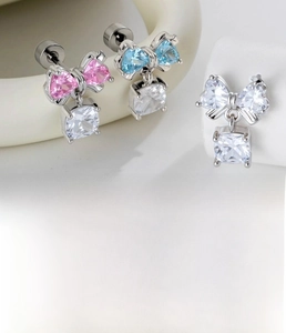 Detailed view of bow-shaped cartilage studs in silver titanium steel with zirconia