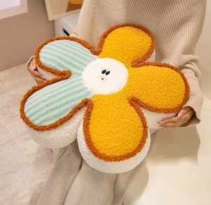 Soft smiling flower plush cushion held in hands, perfect for home sofa or bed decor