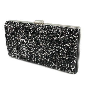Close-up of sparkling black and silver rhinestones on an elegant evening clutch bag