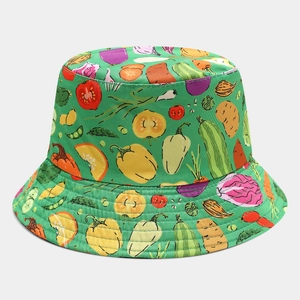 Detail of green bucket hat featuring colorful hand-drawn vegetable patterns and fine stitching