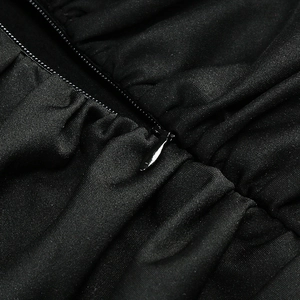 Detail view of a black fishtail dress featuring a hidden zipper and premium fabric texture