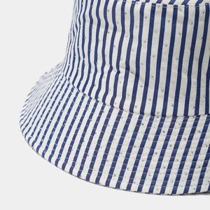 Detail view of blue and white striped canvas fabric with sparkling rhinestone accents
