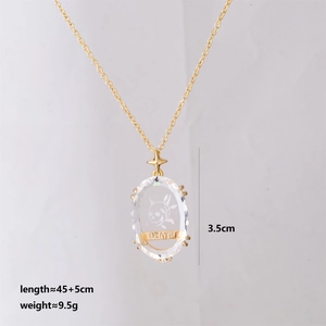 Detail view of gold tarot necklace with skeleton crystal pendant and size dimensions