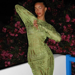 Close-up of green crochet knit maxi dress featuring intricate hollow-out texture details