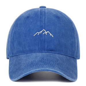 Close-up of vintage washed blue cotton baseball cap featuring minimalist mountain embroidery