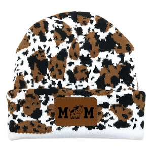 Knitted cow pattern beanie with MOM leather patch and cartoon calf on white background
