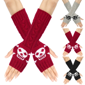 Detailed knit texture of skull pattern fingerless long gloves in red, grey, and black