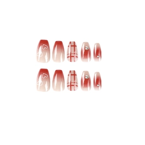 Red gradient press-on nails with white heart patterns, plaid design, and rhinestones