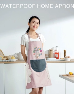 Detail of pink waterproof apron featuring a gray pocket and rabbit pattern in a kitchen
