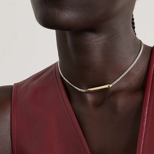 Two-tone stainless steel cuban chain necklace with gold bar pendant on model