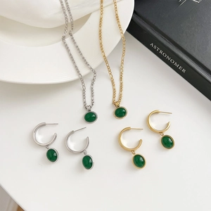 Green aventurine jewelry set with gold and silver necklaces and matching C-hoop earrings
