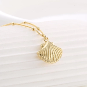 Elegant gold S925 silver necklace with textured shell pendant and delicate beaded chain