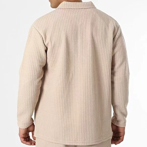 Detail of men's beige waffle texture jacket showing the fabric and back fit on a model