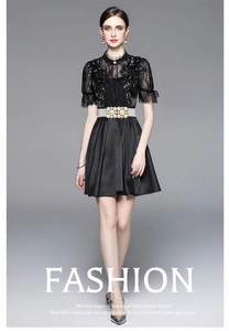 Close-up of black lace patchwork dress with exquisite pearl beaded metal belt detail