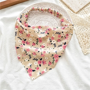 Floral triangle headscarf displayed on a vintage tray with lace and pleated fabric detail