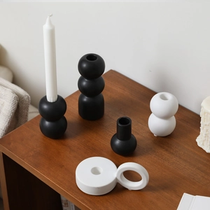 Minimalist black and white ceramic candle holders in geometric shapes for home decor