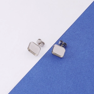 Macro shot of silver square stud earring blanks for DIY jewelry setting and crafts