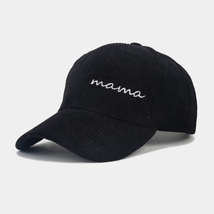 Close-up of black corduroy baseball cap with white mama script embroidery detail