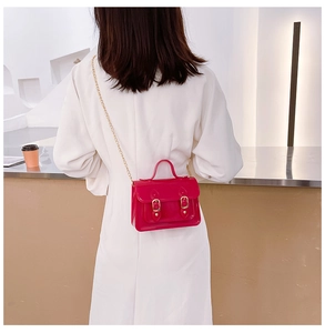 Detailed back view of a stylish mini pink jelly Cambridge bag with a gold chain strap