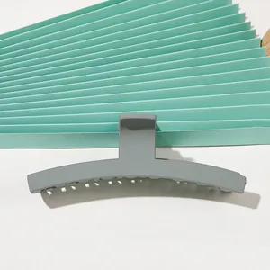 Detail view of large gray matte shark hair claw clip for thick hair styling