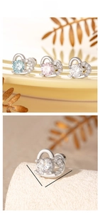 Macro detail of heart-shaped zircon earrings with measurement size 9mm by 8mm